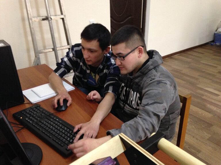 Two people at computer rescuing data
